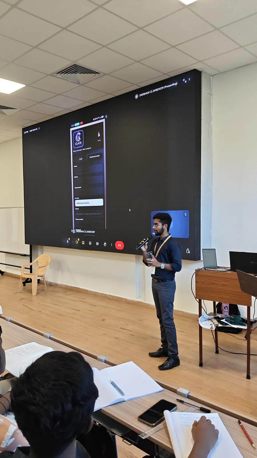 Darshan presenting the CLICK app on a large screen to first-year students