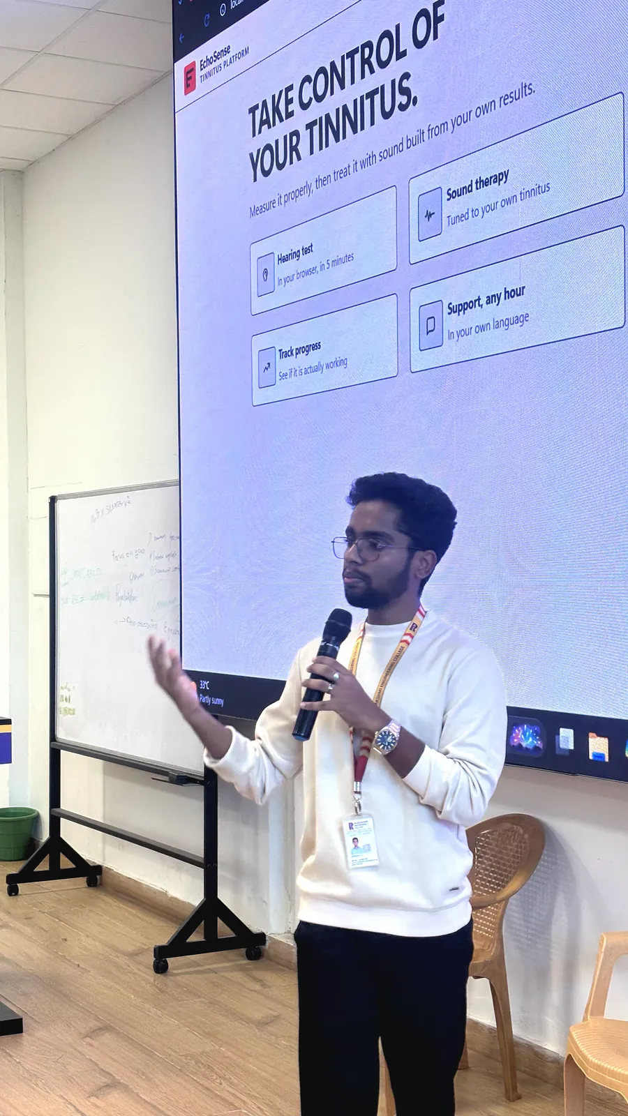 Darshan with a microphone presenting EchoSense on a large screen